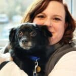 Animal Welfare Association Executive Director Laura Houston holding pet dog.