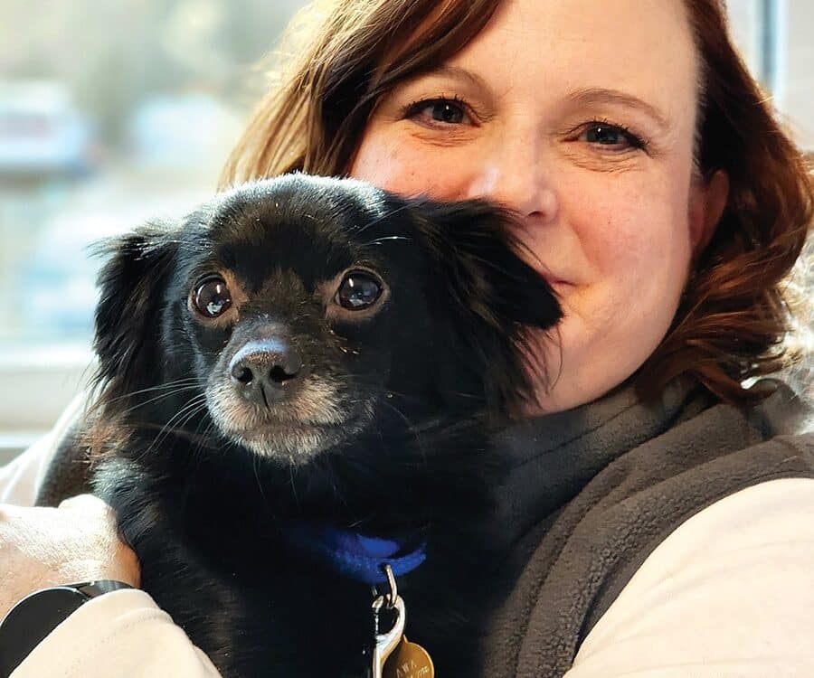 Animal Welfare Association Executive Director Laura Houston holding pet dog.