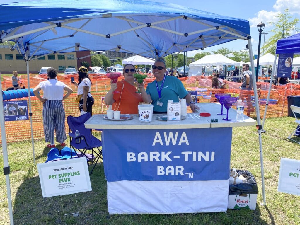 2 women serving dog-friendly drinks at AWA Bark-Tini Bar.