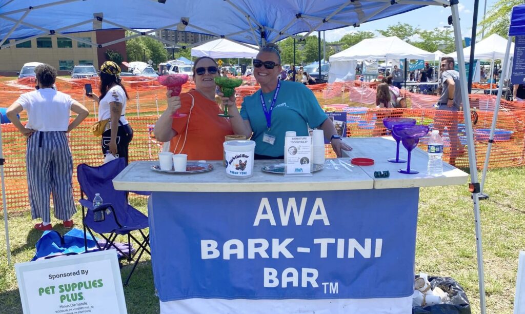 2 women serving dog-friendly drinks at AWA Bark-Tini Bar.