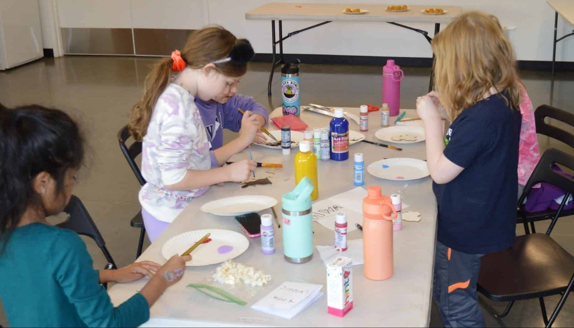 Children at table making arts and crafts at Animal Welfare Association's Kids Day Off Camp.