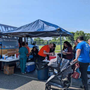 People receiving veterinary care for their pets from a mobile vet clinic.
